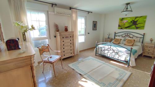 a bedroom with a bed and a dresser at Alcazaba in Torre del Mar