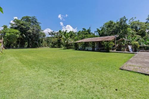 a large yard with a gazebo and grass at Recanto do sossego!! in Morretes