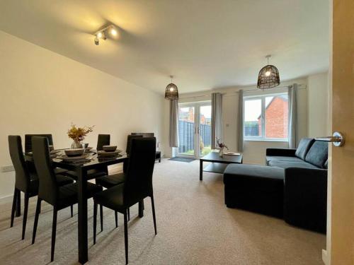 a living room with a table and a couch at Big Modern House - 15min to NEC - Sleeps 10 in Birmingham