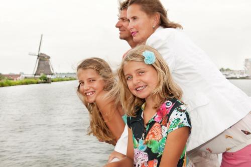 a woman and two girls standing next to the water at Van der Valk Hotel Avifauna in Alphen aan den Rijn