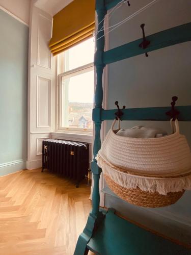 a bedroom with a blue bunk bed with a window at Ben A'an House in Callander