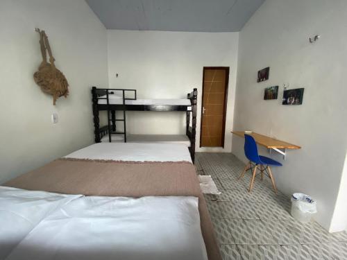 Ένα ή περισσότερα κρεβάτια σε δωμάτιο στο Casa Guarnicê Hostel