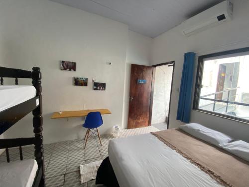 Ένα ή περισσότερα κρεβάτια σε δωμάτιο στο Casa Guarnicê Hostel