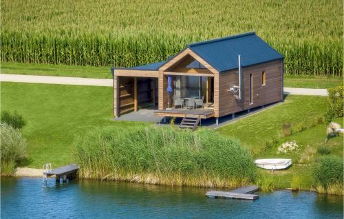 a tiny house on the side of a lake at Ferienhaus Am Naturbadesee in Königsdorf