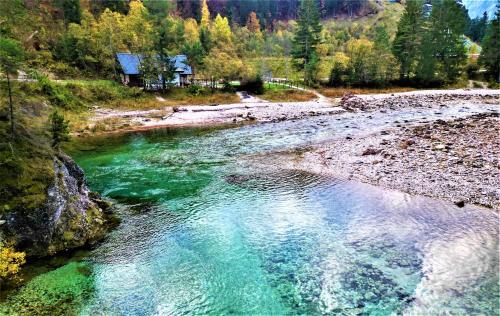 an aerial view of a river with green water at la LUNA delle MONTAGNE Charme & SPA Chalet in Tarvisio