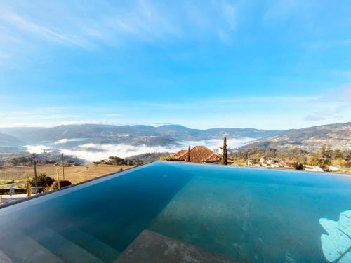 a swimming pool with a view of the mountains at BHDouro in Baião