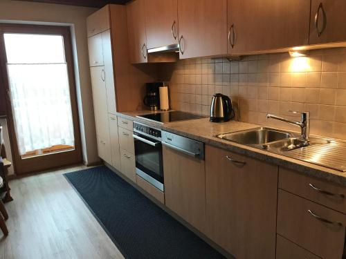 a kitchen with a sink and a stove top oven at Appartement Anja in Fügen