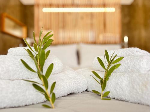 a pile of towels on a table with two plants at BHDouro in Baião