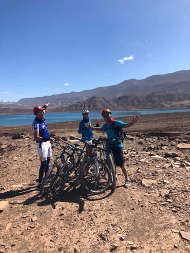 a group of people standing next to their bikes at Auberge restaurant Afoud in Agoudal