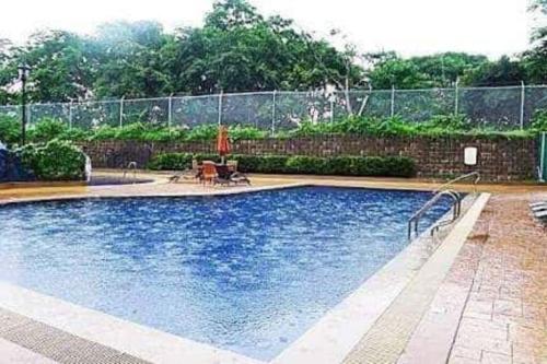 a swimming pool in a yard with a fence at 3 Bedroom in Tuscany Private Estate BGC in Manila