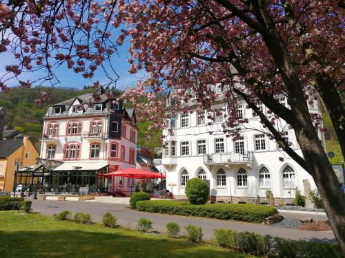 a large white building with a pink at Haus Hohenzollern & Haus 'Ambiente in Bad Bertrich