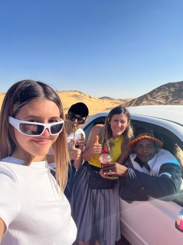 a group of people standing in the back of a car at Wesy Ka Guest House in Aswan