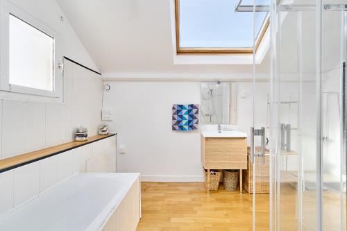 a white kitchen with a sink and a window at Villa Reims Epernay Champagne Vineyard in Villers-Allerand