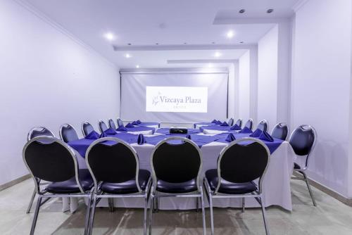 a meeting room with a long table and chairs at Hotel Vizcaya Plaza in Barrancabermeja