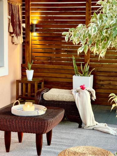 a patio with a bench and a table and plants at Antonakis Villa Rhodes Private Pool & Jacuzzi Retreat in Kremasti