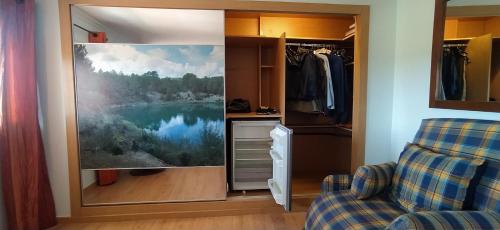 a kitchen with a painting of a lake on the wall at Luz de Carboneras in Carboneras de Guadazaón