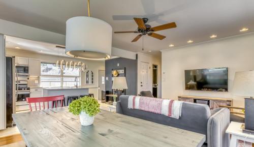 a dining room and living room with a table and a couch at Modern Beach Bungalow, Firepit, Foosball, Hot tub, IN Dunes Natl Park in Miller