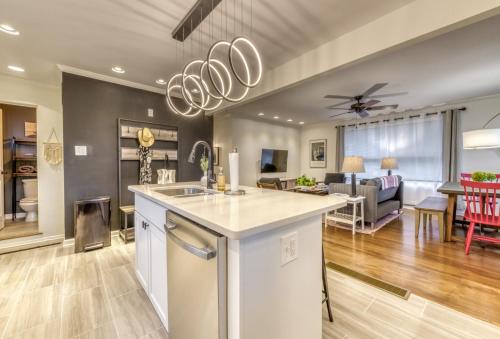 a kitchen and living room with a dining room at Modern Beach Bungalow, Firepit, Foosball, Hot tub, IN Dunes Natl Park in Miller