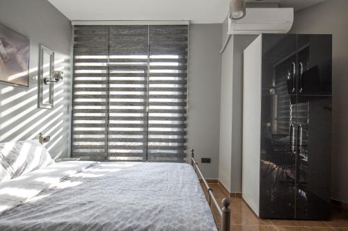 a bedroom with a bed and a large window at Beyoğlu Huzur Apart in Istanbul