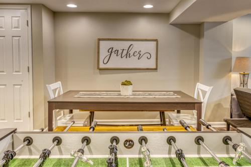 a dining room with a table with hockey equipment at Modern Beach Bungalow, Firepit, Foosball, Hot tub, IN Dunes Natl Park in Miller