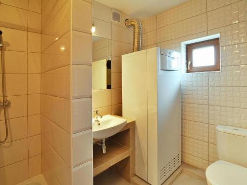 a bathroom with a sink and a toilet at Comfortable holiday home with a nice garden, close to the sea, Sarbinowo in Sarbinowo