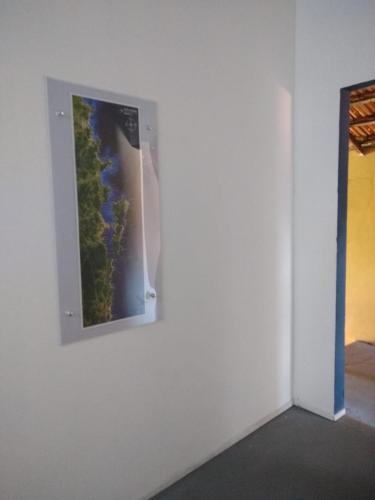 a picture of a river on a wall in a room at Pousada Flay 7 minutos Próximo do Aeroporto de Florianópolis in Florianópolis