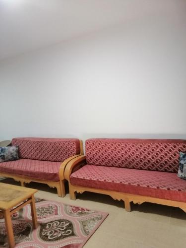 two benches sitting next to each other in a room at شالية بقرية بالميرا in Ain Sokhna