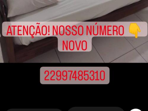 a sign that says argento nazarmetereo and a picture of a bed at Pousada nascente do sol in Macaé
