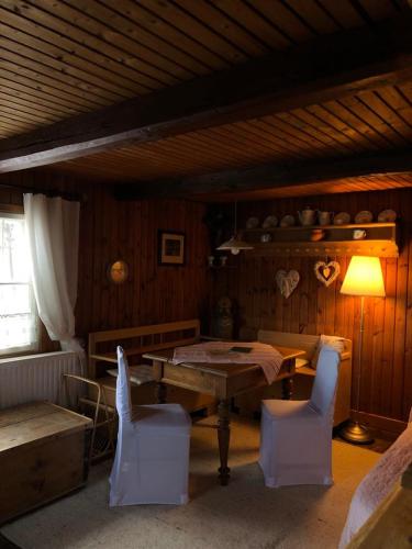 a dining room with a wooden table and chairs at Ferienhaus Pliescherhof in Turnau