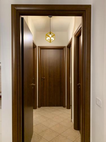 a hallway with wooden doors and a light fixture at Kite Village Solaris in Birgi Vecchi