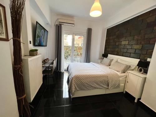 a bedroom with a bed and a desk in a room at Beautiful Studio With Private Yard in Athens