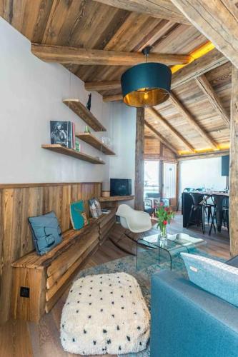 a living room with a blue couch and a table at Top floor appartment, ski in ski out, superb view in La Daille