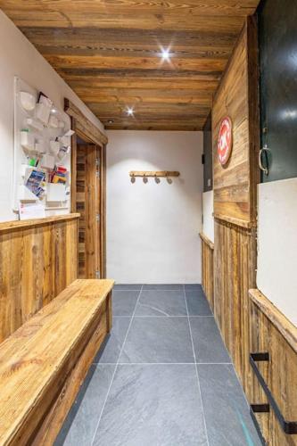 a hallway of a kitchen with wooden walls at Top floor appartment, ski in ski out, superb view in La Daille