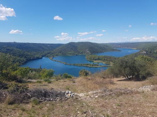 a view of a lake from the top of a hill at Gabi Rooms & Studio Apartment in Lozovac