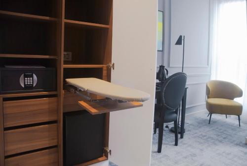 a room with a desk and a chair and a table at H41 Luxury Suites in Belgrade