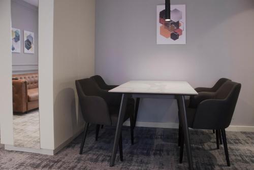 a table and chairs in a waiting room at H41 Luxury Suites in Belgrade