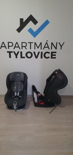 a motorcycle helmet sitting on the floor in front of a sign at Apartmány Tylovice in Rožnov pod Radhoštěm
