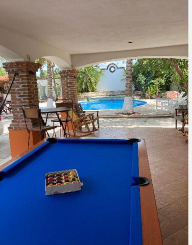 a blue pool table in a room with a swimming pool at Quinta Calandria Haus in Cancún