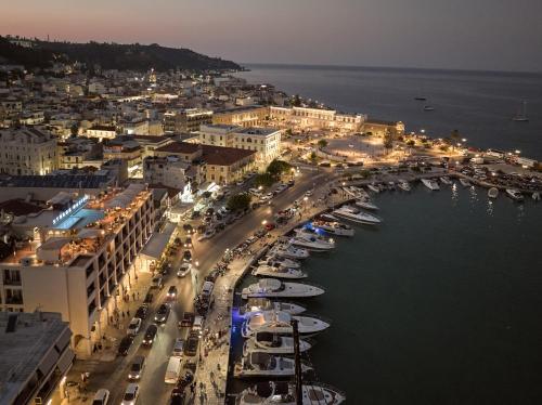 a harbor with boats in the water at night at Strada Marina Hotel in Zakynthos