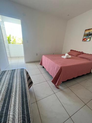 a bedroom with a bed and a large window at POUSADA CENÁRIO IDEAL in Icapuí