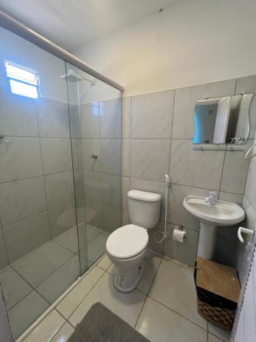 a bathroom with a toilet and a shower and a sink at POUSADA CENÁRIO IDEAL in Icapuí