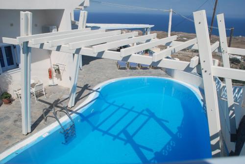 a swimming pool on the side of a house at Erato Apartments in Firostefani