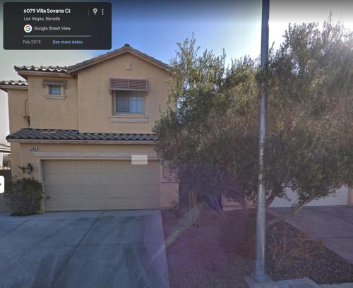 a house with a garage and a tree in front of it at Hotel a Go-Go in Las Vegas