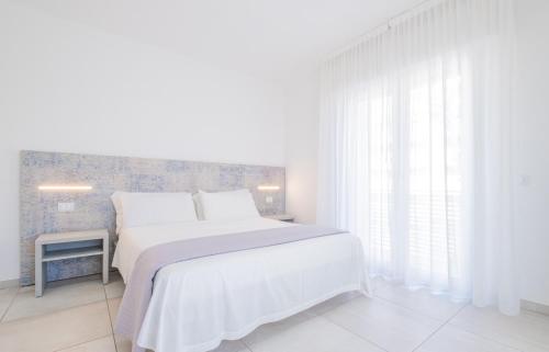 Un pat sau paturi într-o cameră la La Maricita Rimini
