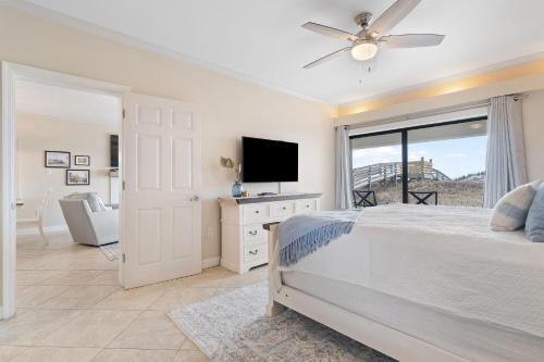 a bedroom with a bed and a flat screen tv at Shipwatch B101 in Perdido Key