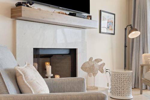 a living room with a couch and a fireplace at Shipwatch B101 in Perdido Key