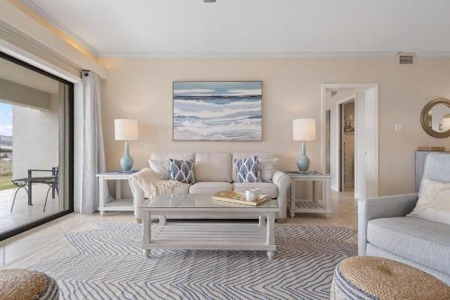 a living room with a couch and a table at Shipwatch B101 in Perdido Key