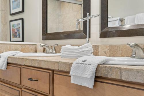 a bathroom with a sink and a mirror and towels at Shipwatch B101 in Perdido Key