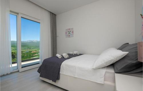 um quarto branco com uma cama e uma grande janela em 4 Bedroom Amazing Home In Imotski em Imotski