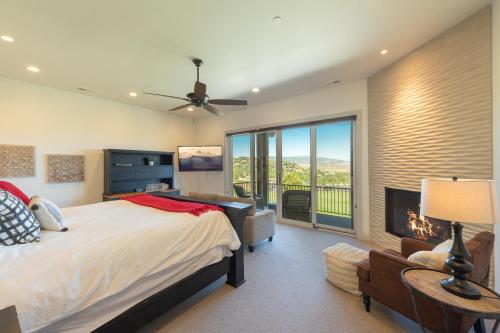 a bedroom with a large bed and a fireplace at Walk to Skiing Exceptional 4 Bedroom plus Den Private Hot Tub Golf Course Views Pool in Park City